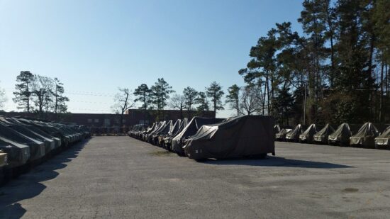 Military vehicles covered for outdoor storage